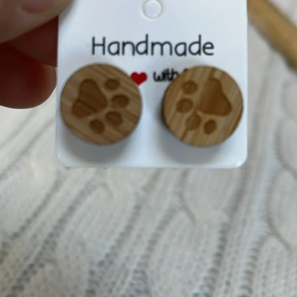 Earrings. Wooden paw prints. .5”. Steel post/backs. Circular Wood grain Handmade